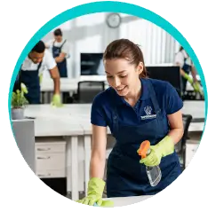 Taprobane Cleaning Solutions cleaner wiping an office desk during professional workplace cleaning in Auckland